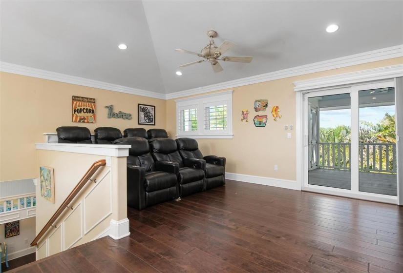 Theater room on third level with access to screened porch and roof top deck