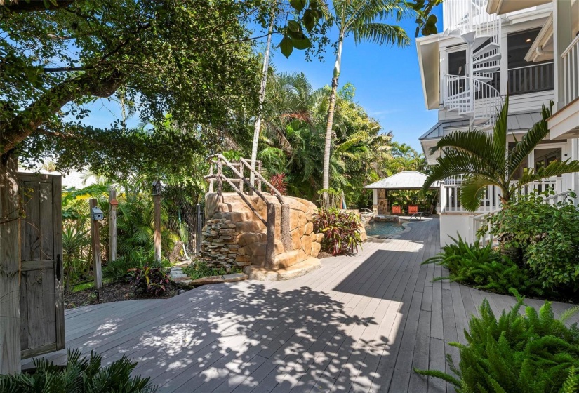 Outdoor pool deck with outdoor shower and spiral stair to porches and roof top deck