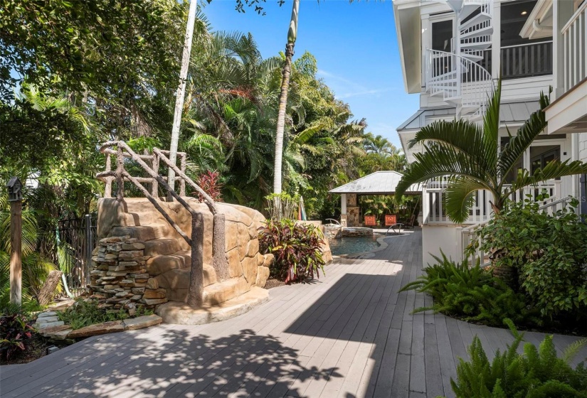 Outdoor pool deck with outdoor shower and spiral stair to porches and roof top deck