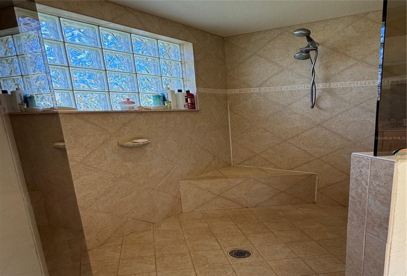 Large walk in shower with bench seat in Owner's Suite bathroom