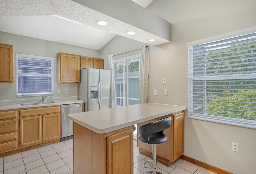 Kitchen has sliding door to pool area