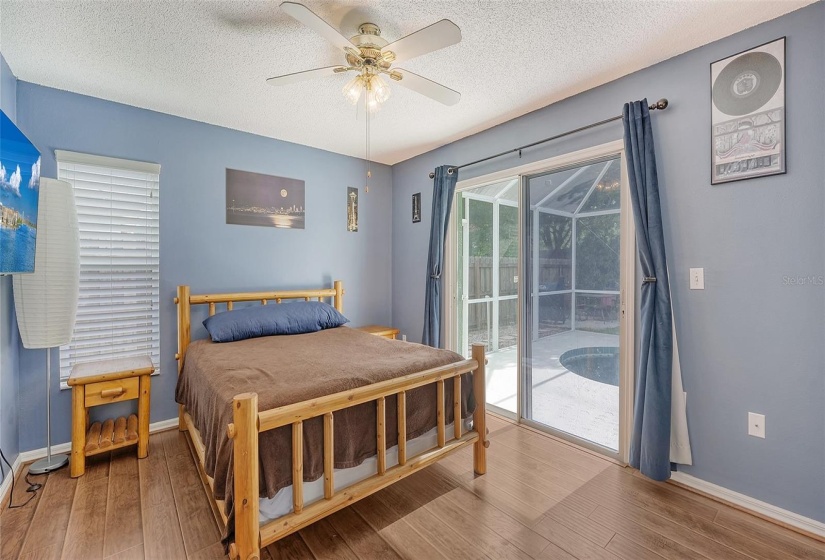 Primary bedroom overlooks pool