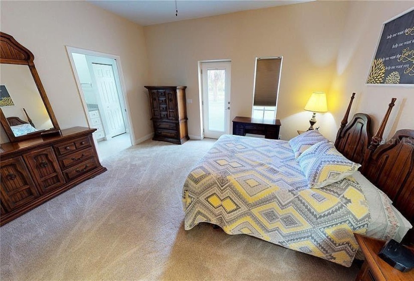 Primary bedroom with backyard access of guest house side of Duplex at Tall Palms Ranch