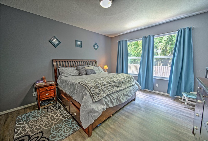 First floor primary bedroom with West facing windows, allowing for gentle light in the morning and beautiful sunsets in the evening