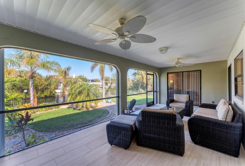 Lanai, Screened in & overlooking Fenced in Yard, Dock & Canal.