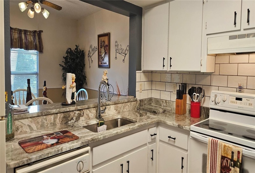 Kitchen with granite counter, subway tile back splash