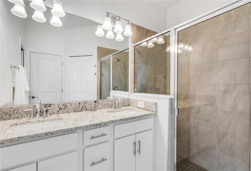 en-suite master bathroom with glass enclosed walk-in shower.