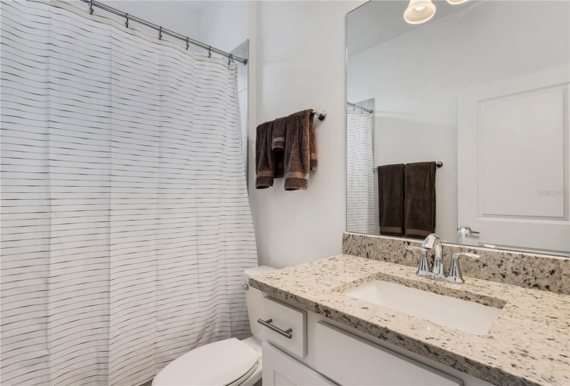 Guest bathroom with tub/shower combination.