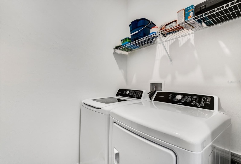 Laundry room with full size washer and dryer.