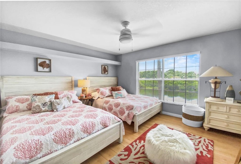 Second bedroom with two queen beds, walk in closet and water view