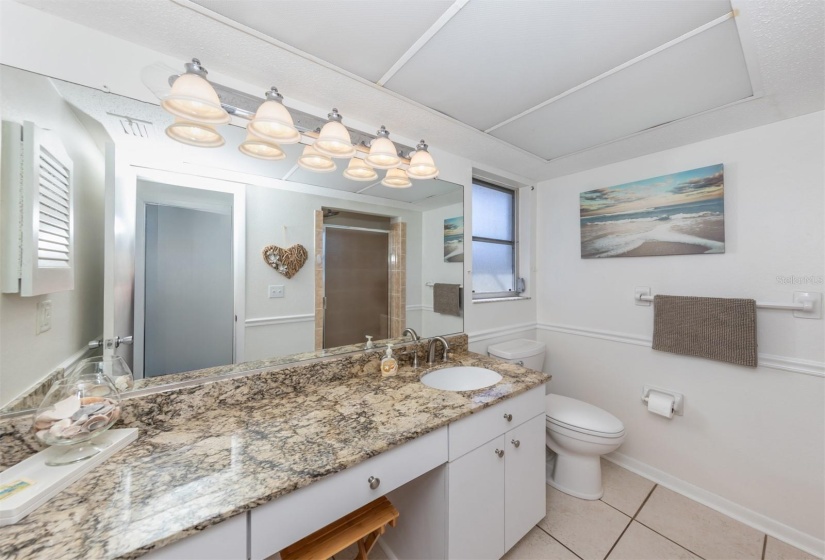 Primary bathroom with enough countertop space to get ready in the mornings with built in space with a chair.  A plus for those that need the space to get yourself going on a daily basis.