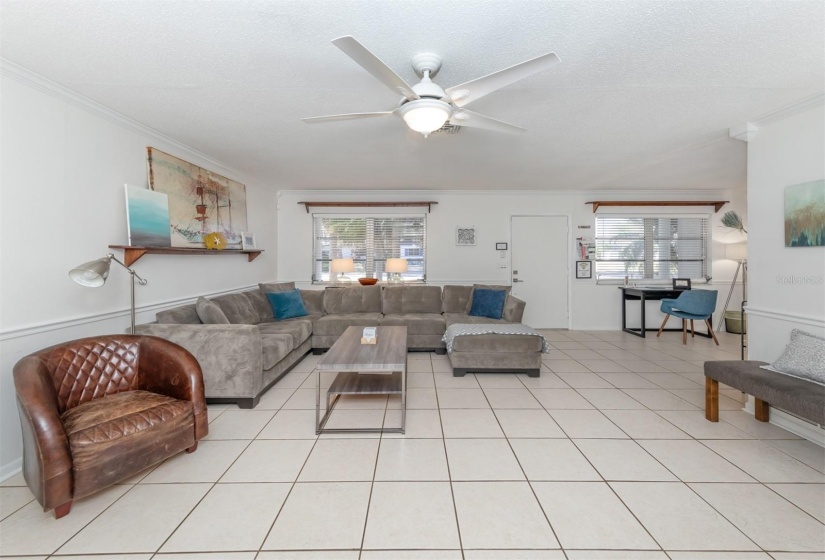 Relax and watch TV or read a book in this spacious living room. This home is being sold with all of this furniture.