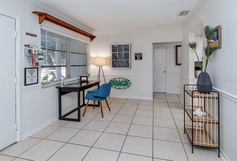 Cozy corner to enjoy quiet time. This space faces the front yard. Furniture being left with home.