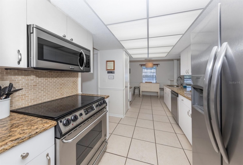 Stainless steel appliances and plenty of granite countertops space to be useful in the kitchen.