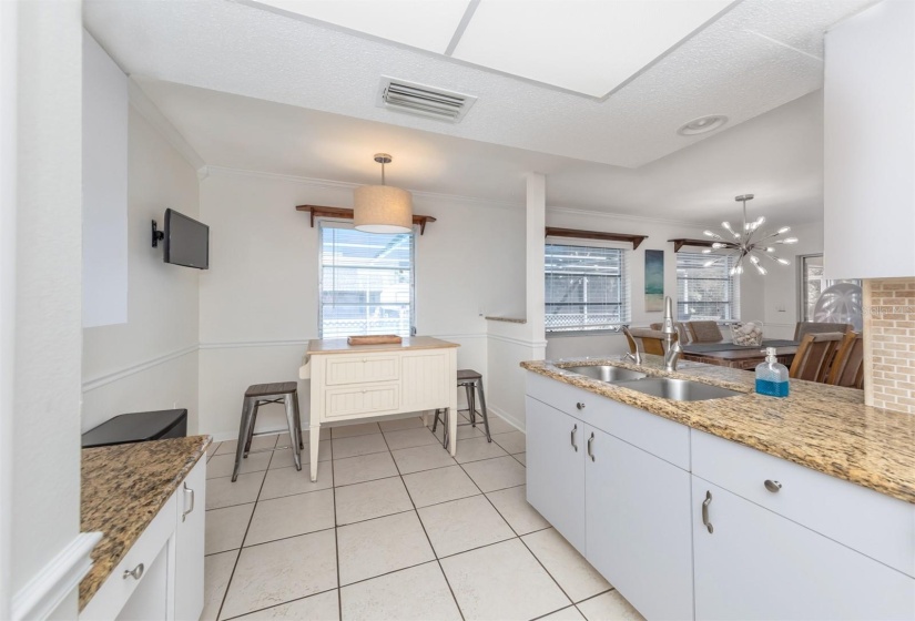 Kitchen nook over looks the pool, backyard area, dining room and living room.  Comes in handy when you have a full house of family members or guests.