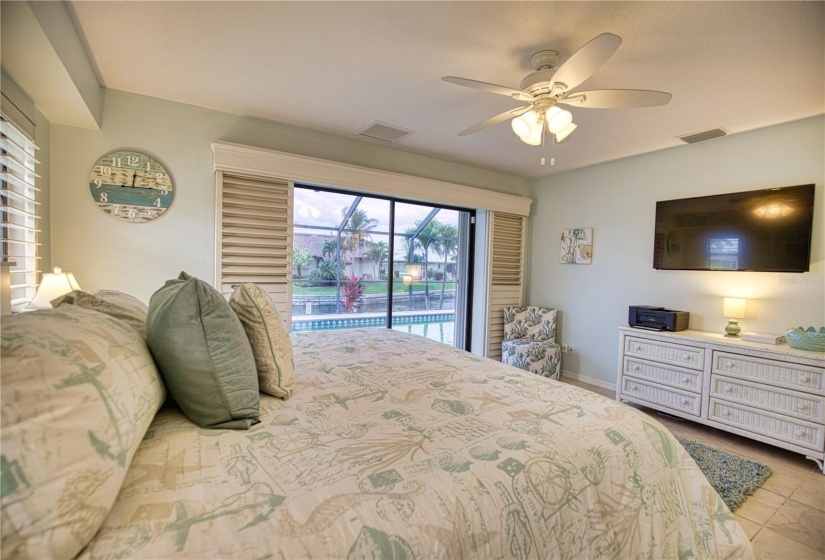 Primary bedroom with canal & pool view