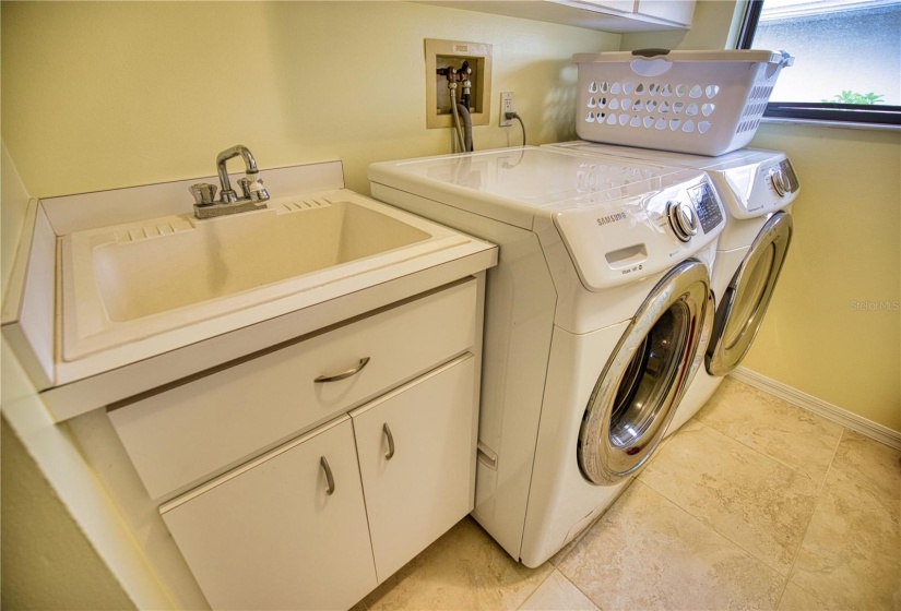 Laundry Room with built in cabinets above and sink